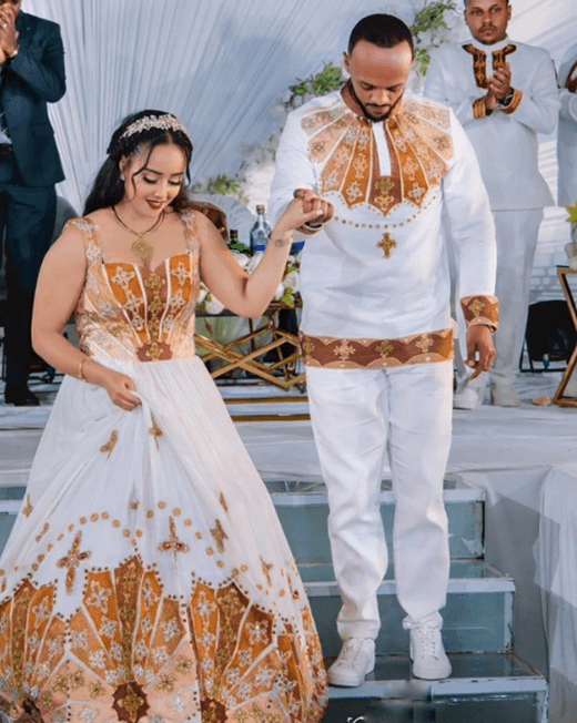 Regal Union: Ethiopian Wedding Couple's Attire in Gold and White Tillet | ETH_Cp - 0001CouplesKaba StoreKaba StoreXSAll agesCustomizableEthiopian Wedding Couple's Attire in Gold and White Tillet Ethiopian traditional clothes Habesha Kemis Ethiopian dress Habesha dress Ethiopian Men's Suit Habesha Suit Ethiopian clothing Habesha clothing 